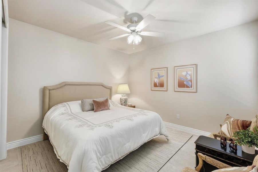 Bedroom with baseboards and a ceiling fan
