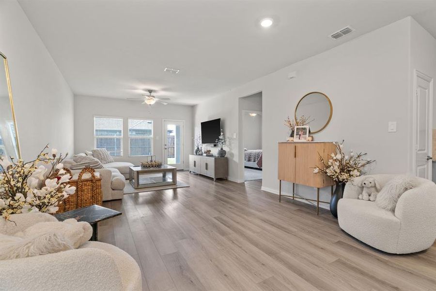 Living room with light wood-type flooring and ceiling fan Living room with light wood-type flooring and ceiling fan