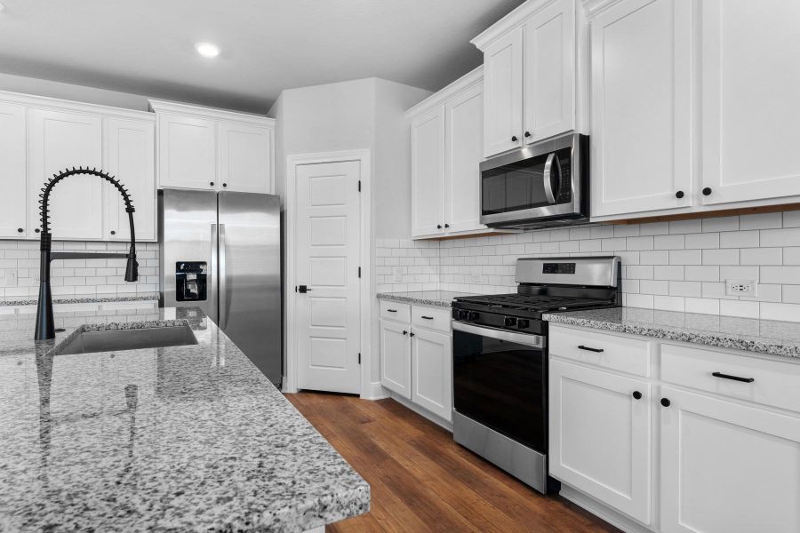 Granite countertops and stainless steel appliances complete this well-appointed kitchen. Granite countertops and stainless steel appliances complete this well-appointed kitchen.