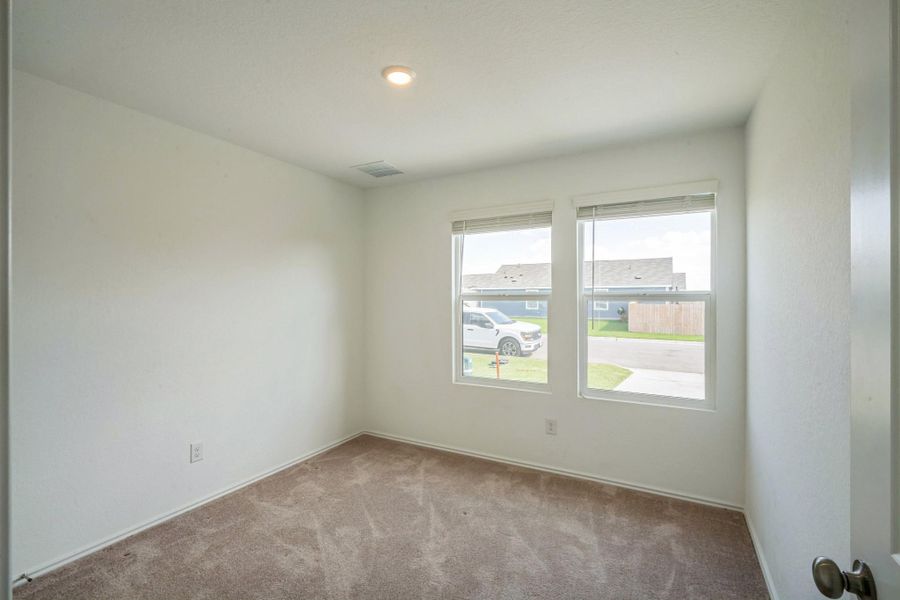 A well-lit room featuring ample natural light from twin windows, perfect for versatile use. A well-lit room featuring ample natural light from twin windows, perfect for versatile use.