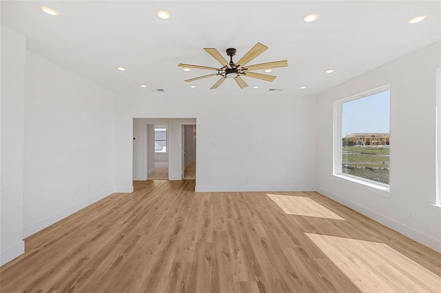 Empty room featuring light hardwood / wood-style flooring and ceiling fan