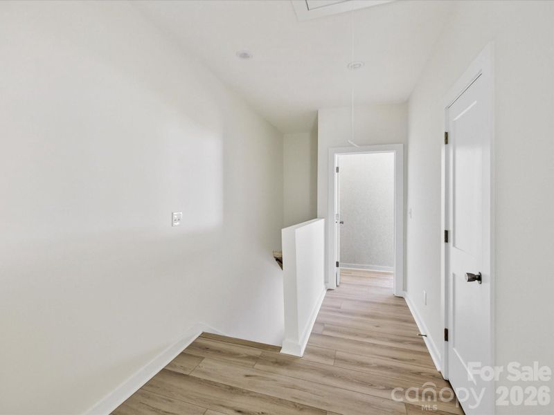 Spacious upper-level landing with clean finishes and versatile space ideal for a small workspace, reading nook, or added functionality. Spacious upper-level landing with clean finishes and versatile space ideal for a small workspace, reading nook, or added functionality.