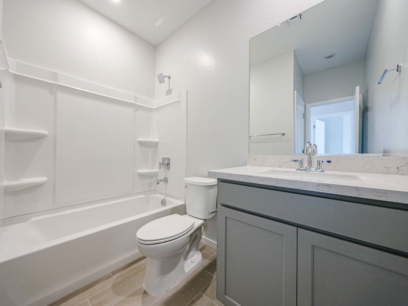 A bathroom with a tub toilet and sink.