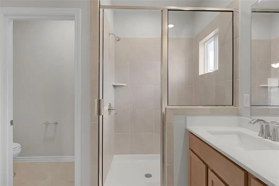 Bathroom with a stall shower, vanity, and tile patterned floors