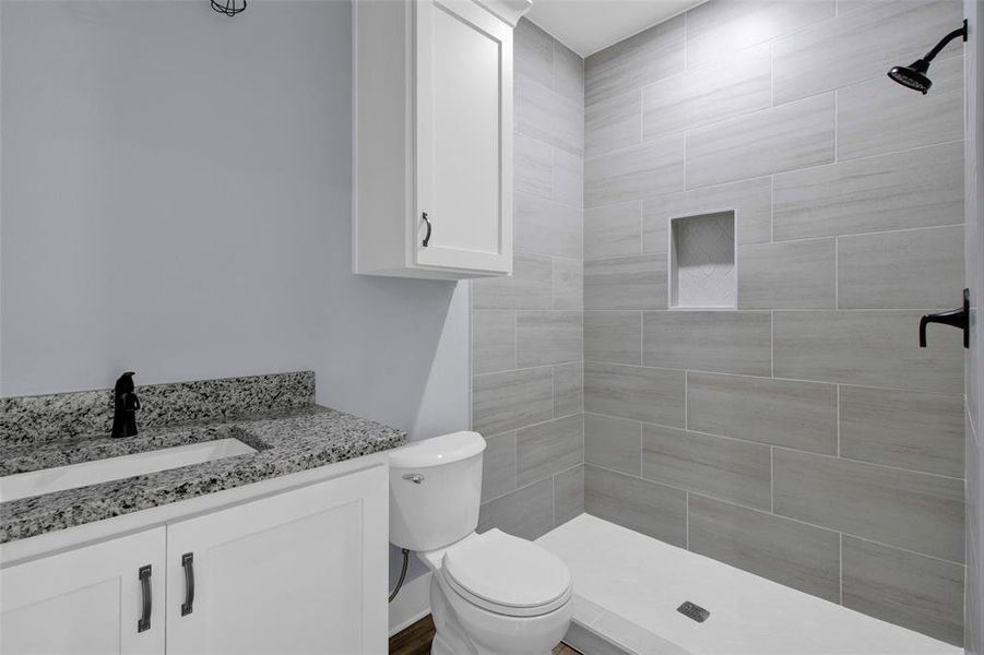 Full bathroom featuring vanity and a stall shower