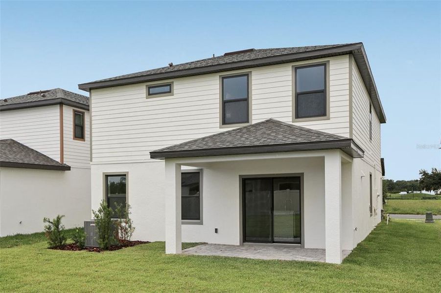 Front exterior of a new home in Grasslands West, Lakeland, FL, highlighting curb appeal (Image 22).