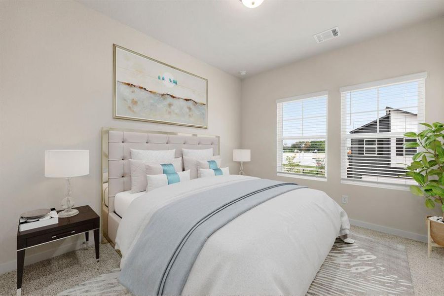 Secondary bedroom features plush carpet, neutral paint, large windows and ample closet space.