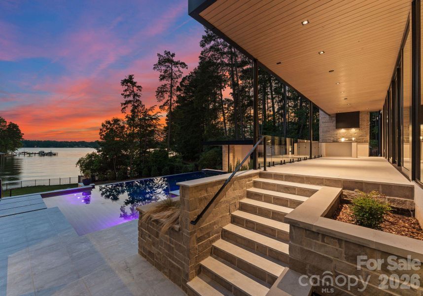 Exterior covered patio featuring outdoor kitchen and grilling area. Exterior covered patio featuring outdoor kitchen and grilling area.