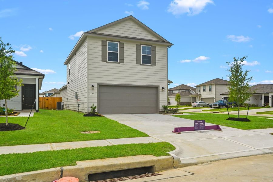 Front exterior of a new home in Barrett Crossing, Crosby, TX, highlighting curb appeal (Image 17). Front exterior of a new home in Barrett Crossing, Crosby, TX, highlighting curb appeal (Image 17).