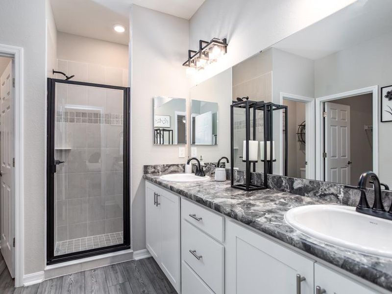 Luxurious en-suite owner`s bath with dual vanities and enclosed shower or choose to add a garden tub for even more at-home relaxation - Summerlyn ll home plan by Highland Homes