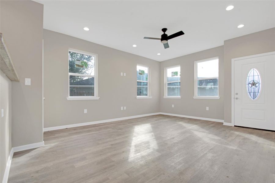 Foyer with plenty of natural light, light wood finished floors, a ceiling fan, and recessed lighting
