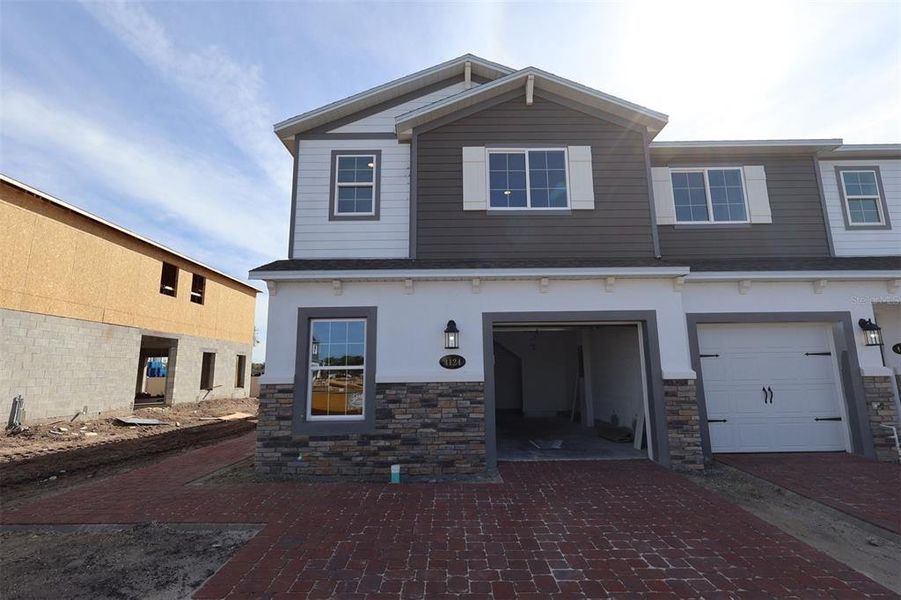 Front exterior of a new home in Tyson Ranch, Orlando, FL, highlighting curb appeal (Image 12).