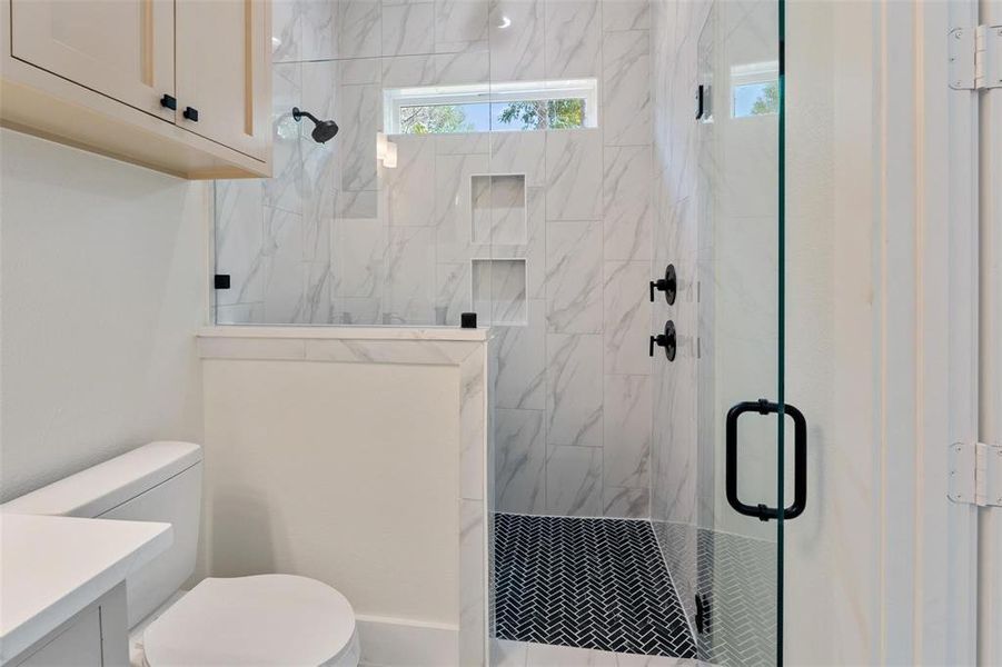 Full bathroom with vanity and a marble finish shower