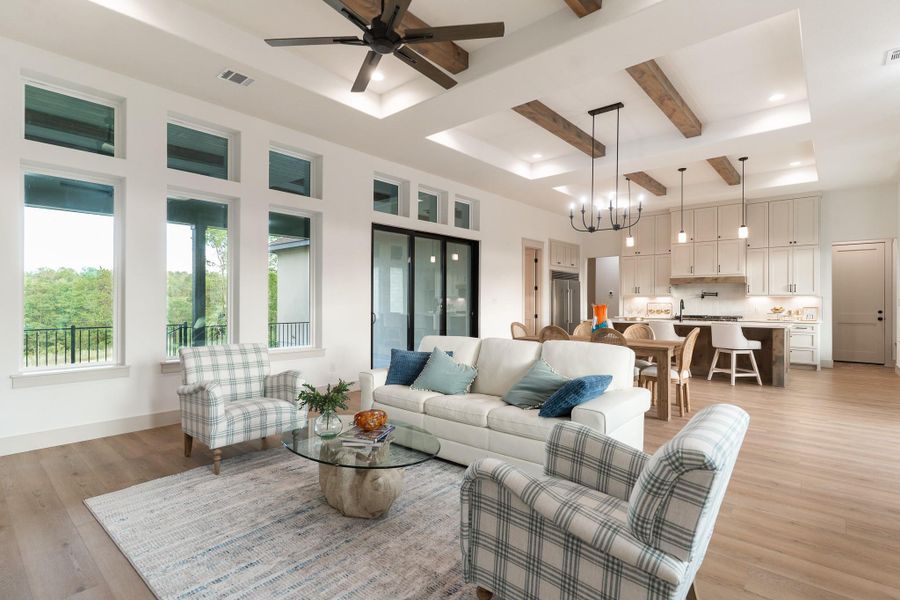 Living room with beam ceiling, light wood-style floors, a chandelier, a ceiling fan, and recessed lighting Living room with beam ceiling, light wood-style floors, a chandelier, a ceiling fan, and recessed lighting