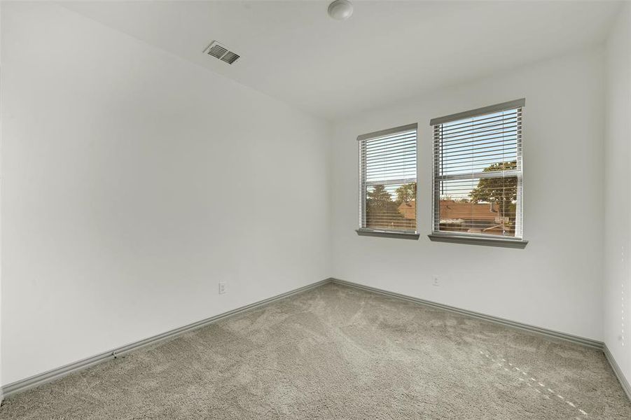 Carpeted spare room with baseboards Carpeted spare room with baseboards