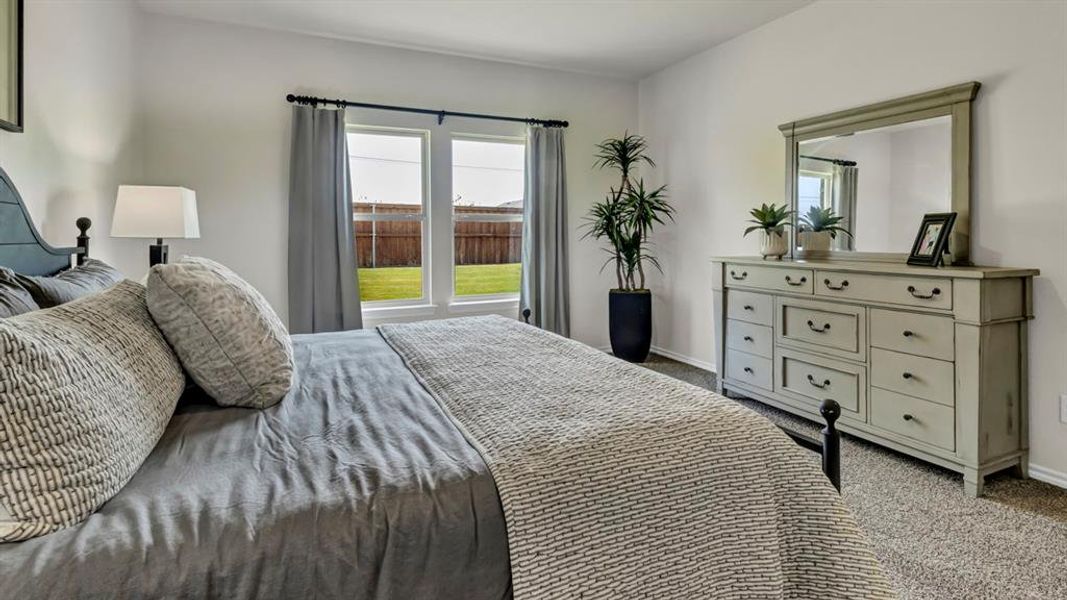 Bedroom featuring neutral wall colors and carpeted flooring Bedroom featuring neutral wall colors and carpeted flooring