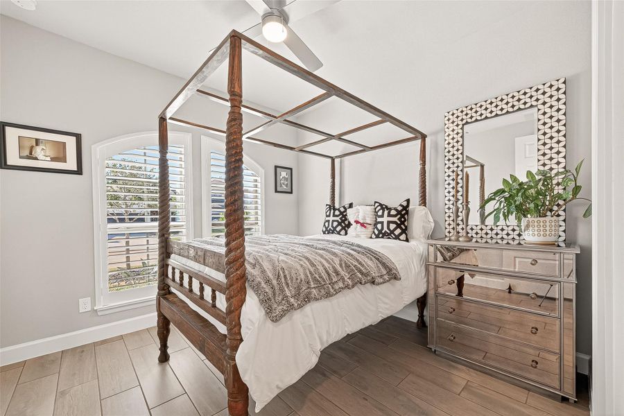 Secondary bedroom located at the front of the home featuring a private ensuite bathroom. (Note: Photo is staged; property is currently vacant.) Secondary bedroom located at the front of the home featuring a private ensuite bathroom. (Note: Photo is staged; property is currently vacant.)