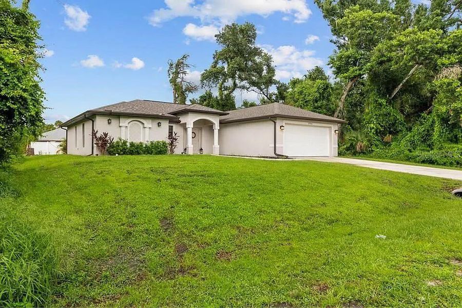 Front exterior of a new home in , Port Charlotte, FL, highlighting curb appeal (Image 1). Front exterior of a new home in , Port Charlotte, FL, highlighting curb appeal (Image 1).