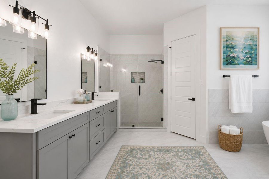 Spa bathroom with dual vanities, separate glass shower, modern lighting and his/hers closets. Spa bathroom with dual vanities, separate glass shower, modern lighting and his/hers closets.