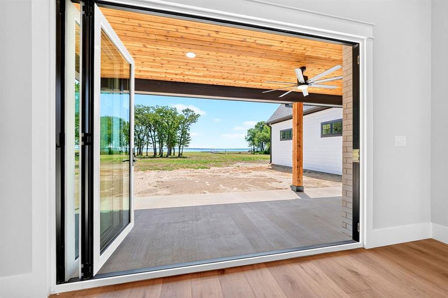 Experience the ultimate indoor-outdoor living! A multi-panel accordion glass door that fully opens to seamlessly blend the interior space with an expansive covered patio featuring a gorgeous cedar tongue-and -groove ceiling and beautiful lake views. Experience the ultimate indoor-outdoor living! A multi-panel accordion glass door that fully opens to seamlessly blend the interior space with an expansive covered patio featuring a gorgeous cedar tongue-and -groove ceiling and beautiful lake views.