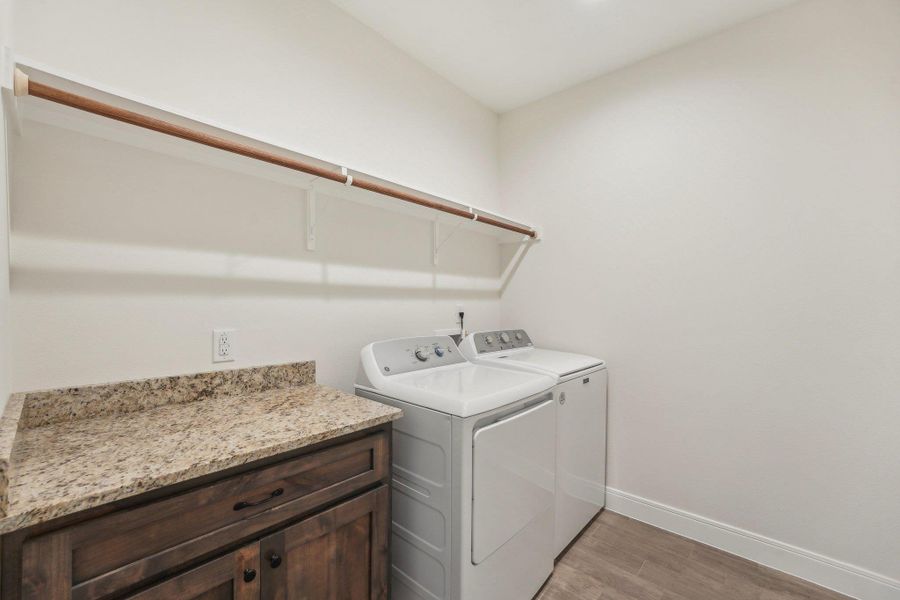 Laundry room featuring light wood-plant Tile floor, baseboards, washer and dryer, and laundry area Laundry room featuring light wood-plant Tile floor, baseboards, washer and dryer, and laundry area