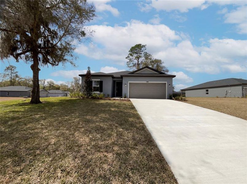 Front exterior of a new home in Grand Park, Dunnellon, FL, highlighting curb appeal (Image 2).