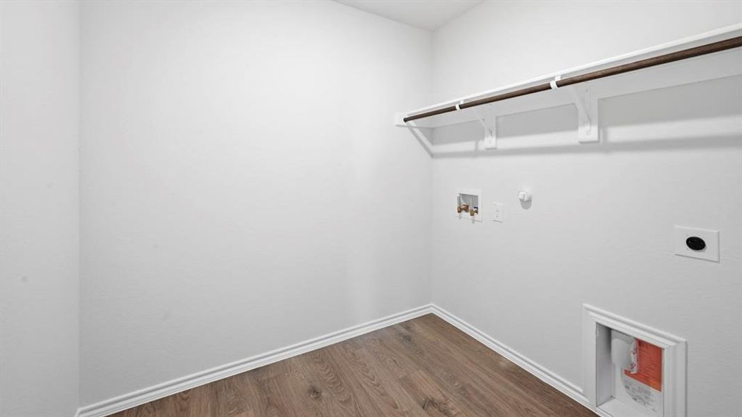 Laundry area featuring gas dryer hookup, dark wood-style floors, hookup for a washing machine, and electric dryer hookup Laundry area featuring gas dryer hookup, dark wood-style floors, hookup for a washing machine, and electric dryer hookup