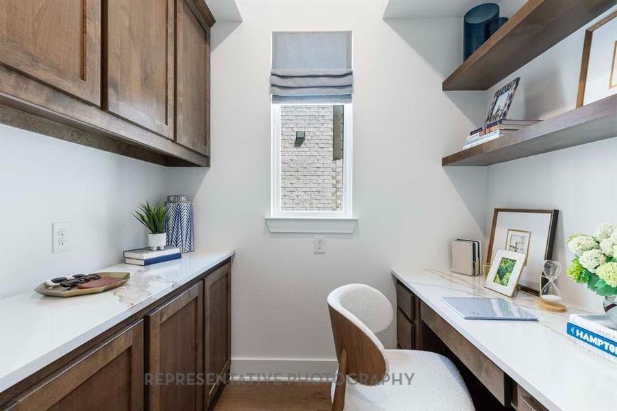 Office area with built in study area and baseboards Office area with built in study area and baseboards