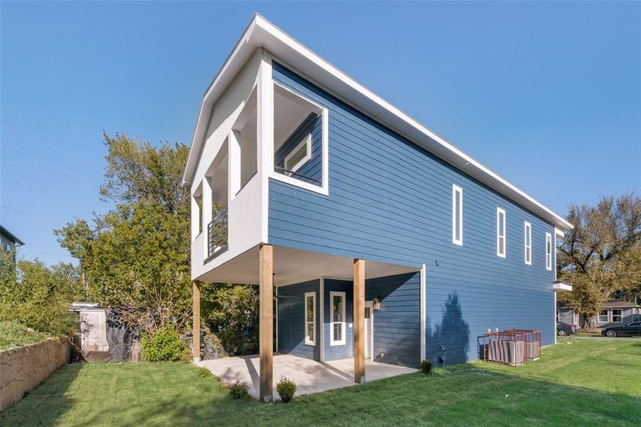 Rear view of property with a yard and a patio area Rear view of property with a yard and a patio area
