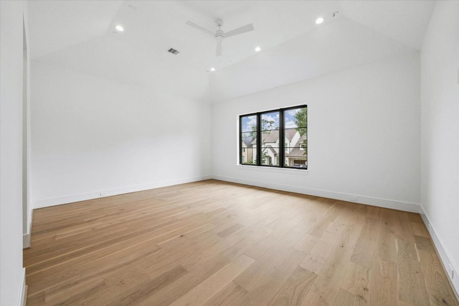 Primary Bedroom with vaulted ceilings and overlooking serene landscaping.