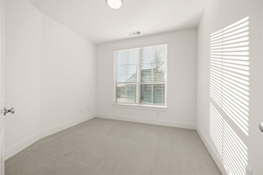 Empty room with baseboards and light carpet