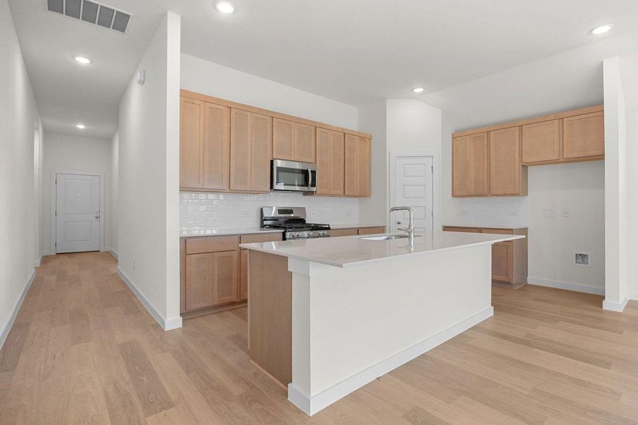 Kitchen in the Sabine home plan by Trophy Signature Homes – REPRESENTATIVE PHOTO