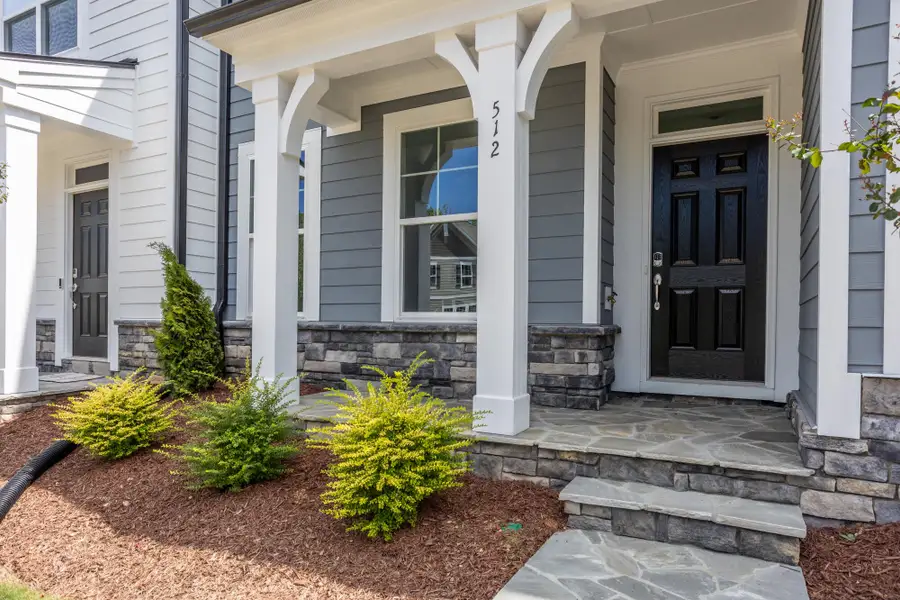 Exterior details and patio area of a home in Enclave at Traditions Townhomes, Wake Forest (Image 3).