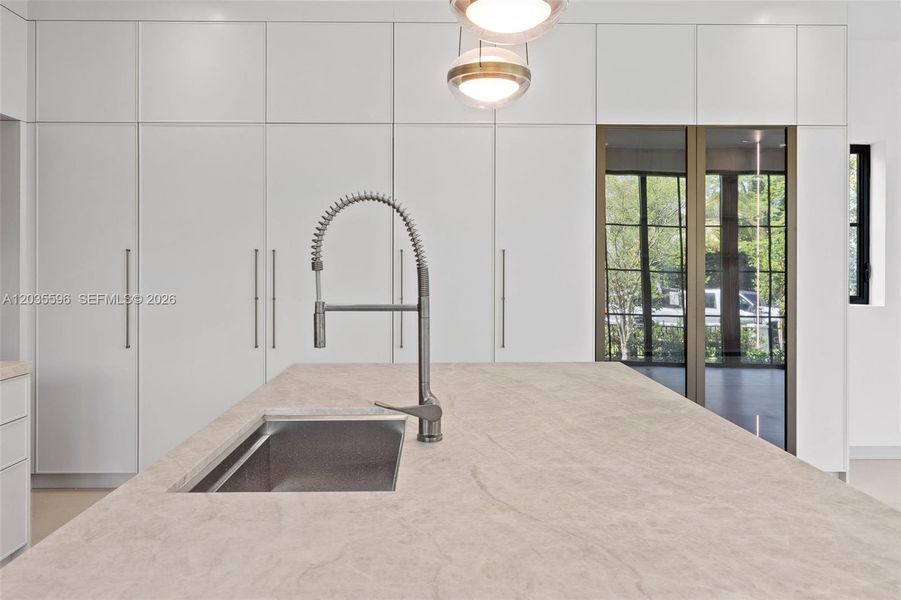 Kitchen island has cabinets beneath it Kitchen island has cabinets beneath it