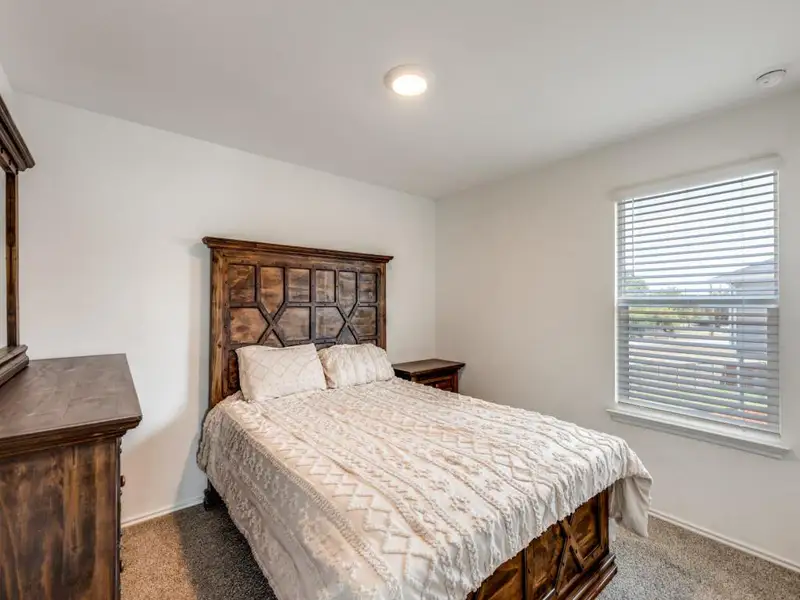 Bedroom featuring carpet flooring and baseboards