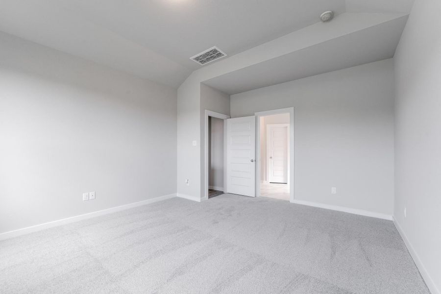 Come decompress in the stunning primary suite after a lengthy day! Experience the luxury of plush carpeting, warm paint hues, high ceilings, and large windows featuring privacy blinds. Sample photo of completed home with similar floor plan. As-built interior colors and selections may vary.