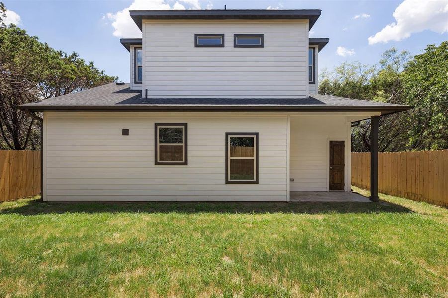 Rear view of house with a lawn