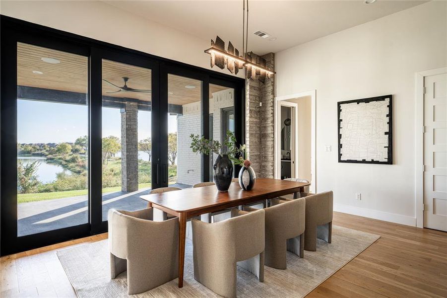 Dining room featuring a water view and light hardwood / wood-style flooring