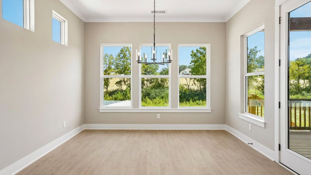 Dining area with various windows next to backyard door Dining area with various windows next to backyard door