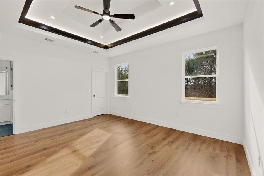 Spare room with light wood finished floors and a ceiling fan Spare room with light wood finished floors and a ceiling fan