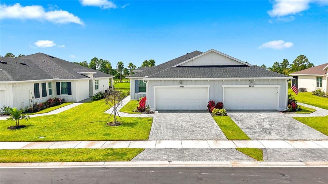 Front exterior of a new home in The Timbers at Everlands, Palm Bay, FL, highlighting curb appeal (Image 28).