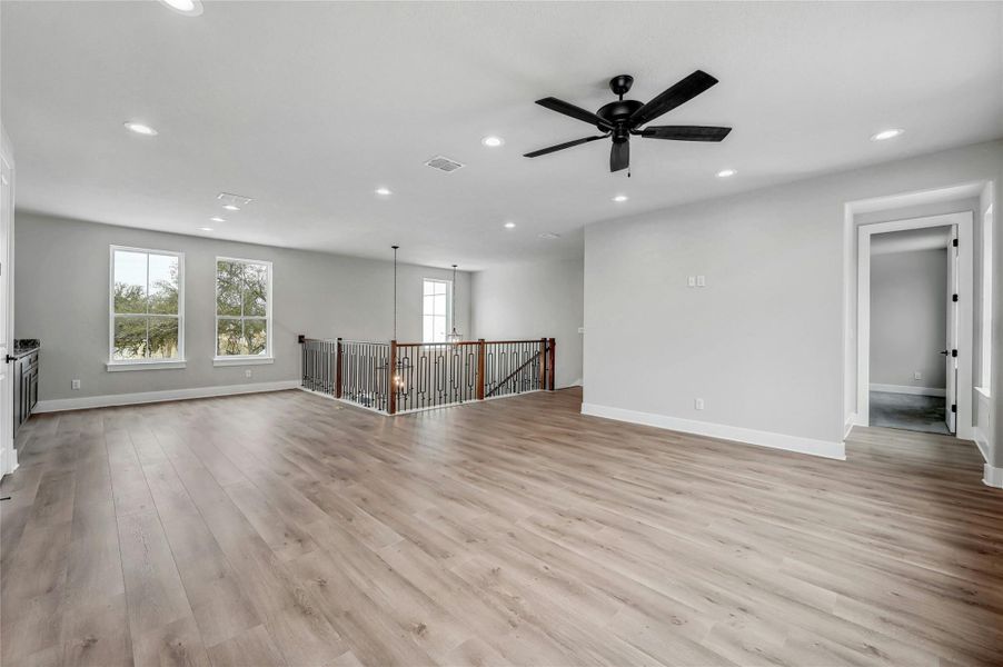 Spare room with baseboards, light wood finished floors, visible vents, and recessed lighting