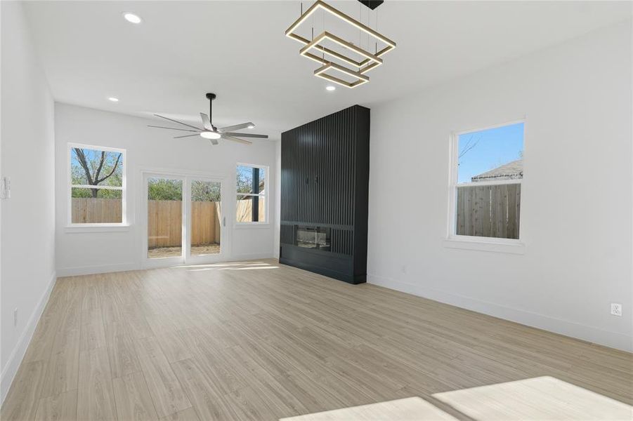 Unfurnished living room featuring a ceiling fan, light wood-type flooring, and recessed lighting Unfurnished living room featuring a ceiling fan, light wood-type flooring, and recessed lighting