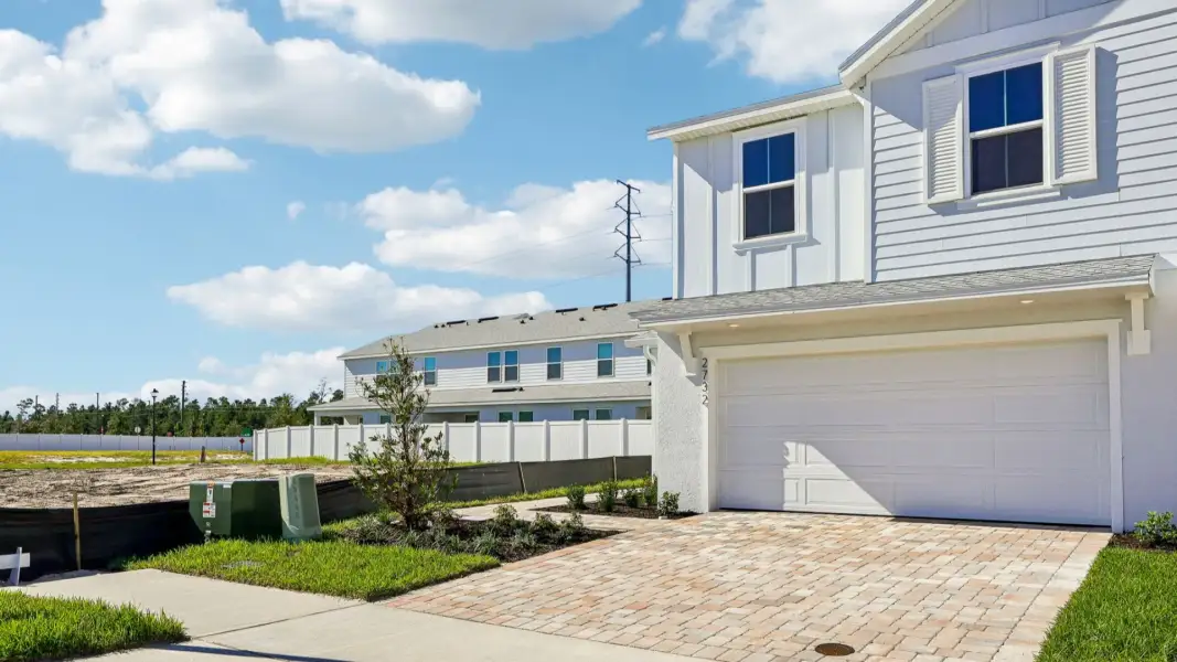 Front exterior of a new home in Cyrene at Harmony, St. Cloud, FL, highlighting curb appeal (Image 2). Front exterior of a new home in Cyrene at Harmony, St. Cloud, FL, highlighting curb appeal (Image 2).