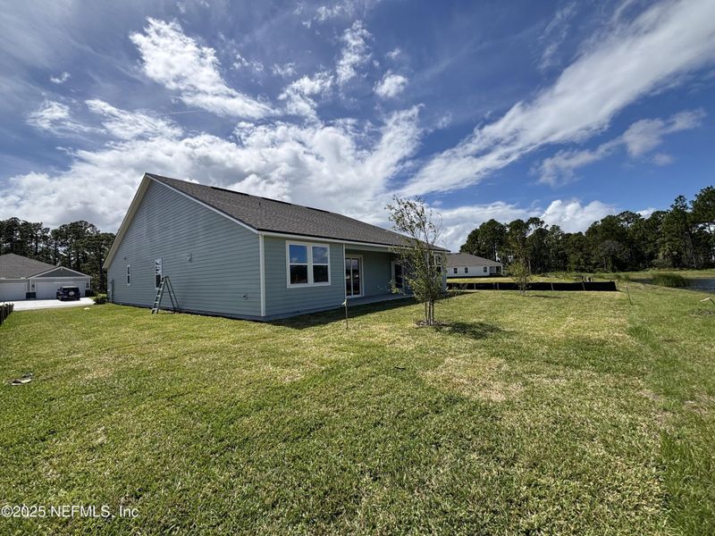 Front exterior of a new home in The Cypress Series at Reserve East, Flagler Beach, FL, highlighting curb appeal (Image 1).