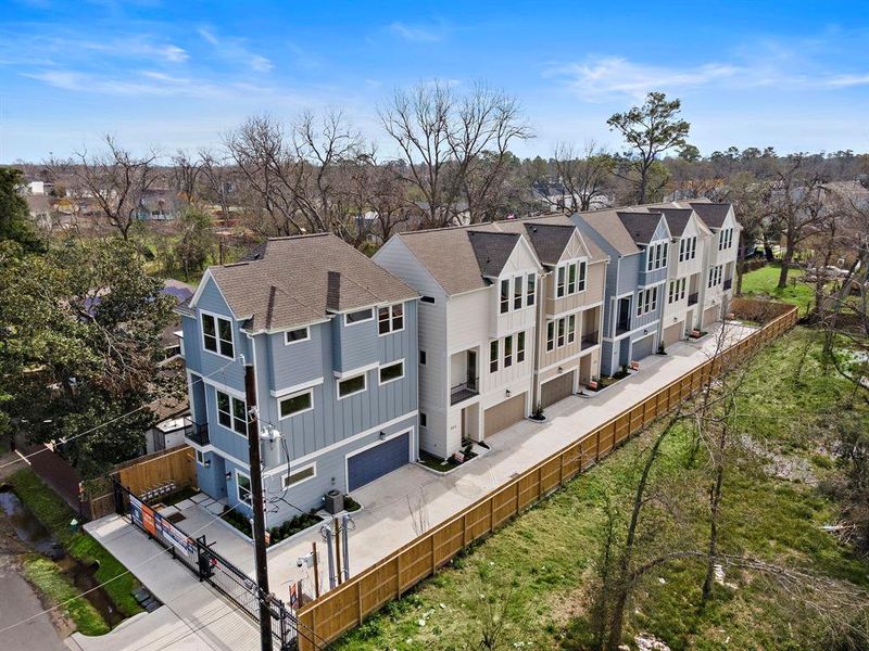 Modern townhomes nestled in a serene, tree-lined community, offering a perfect blend of privacy and convenience.