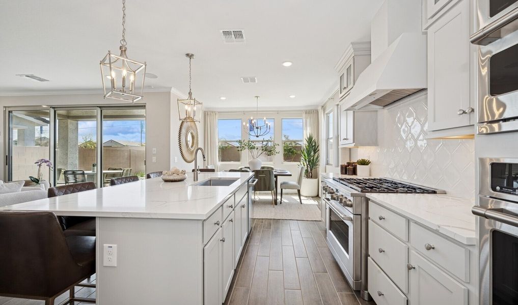 Kitchen with hexagonal backsplash and pendant lighting