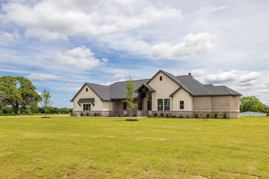 Front exterior of a new home in Prairie Winds Estates, Poolville, TX, highlighting curb appeal (Image 23). Front exterior of a new home in Prairie Winds Estates, Poolville, TX, highlighting curb appeal (Image 23).