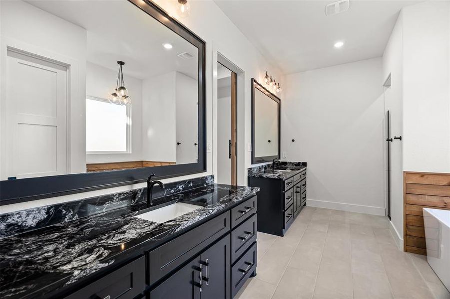 Bathroom with a bathing tub and vanity