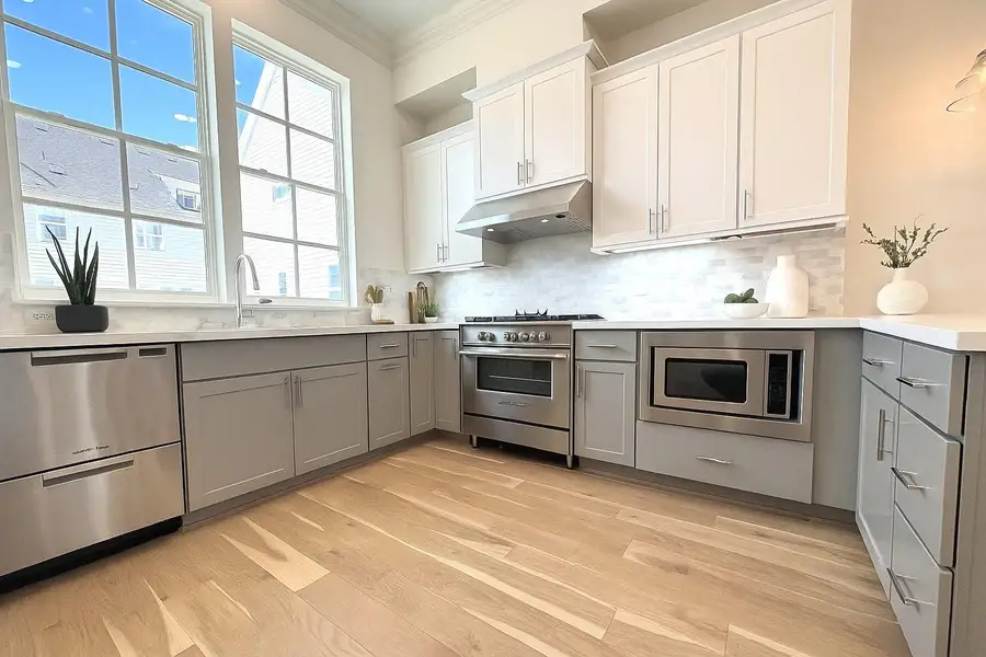 HUGE windows in the kitchen bring in tons of light!   Partial virtual staging added.